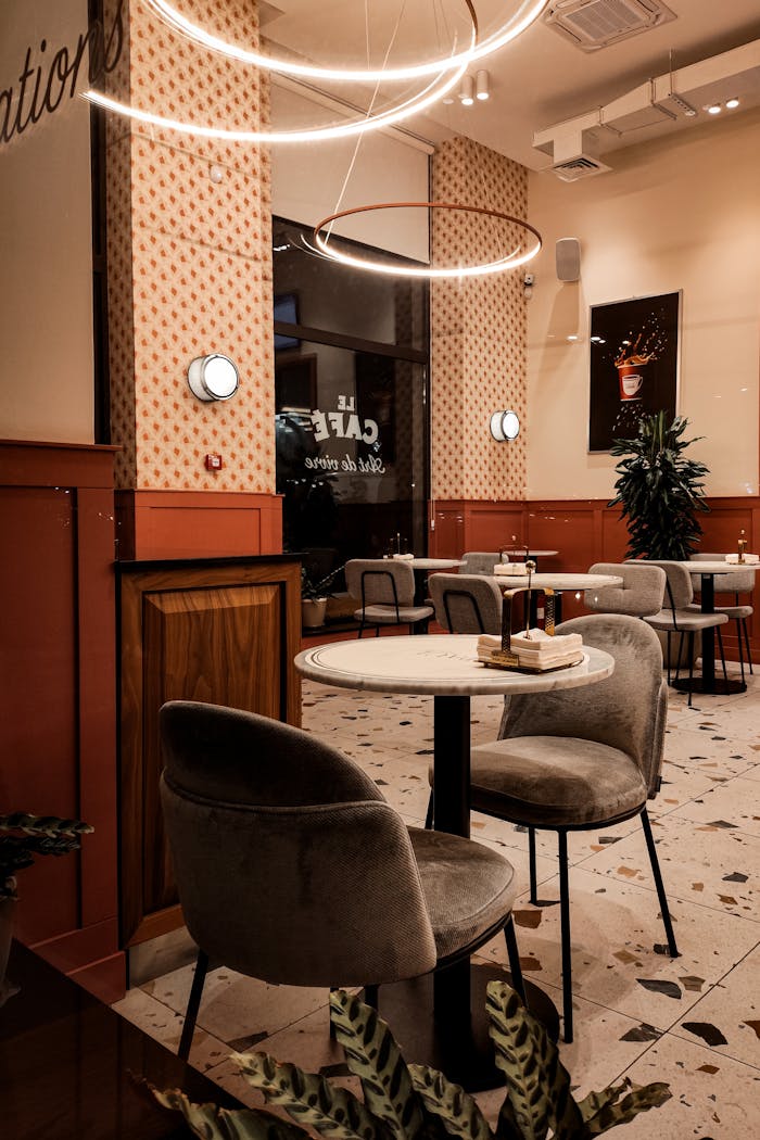 Home Warm and inviting cafe interior in Yerevan, Armenia with modern furnishings and ambient lighting.